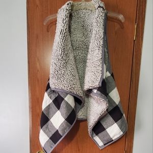 Really cute black Buffalo print reversible vest.
